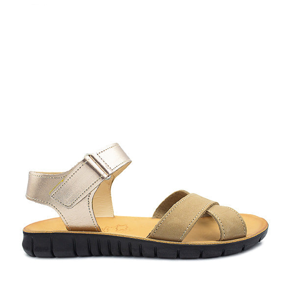 A nude and rose gold colored sandal with a buckle strap and flat heel.