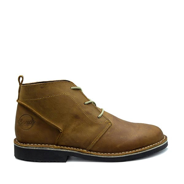 A brown handcrafted leather shoe with a black sole and lace-up closure, featuring the Bouch logo.