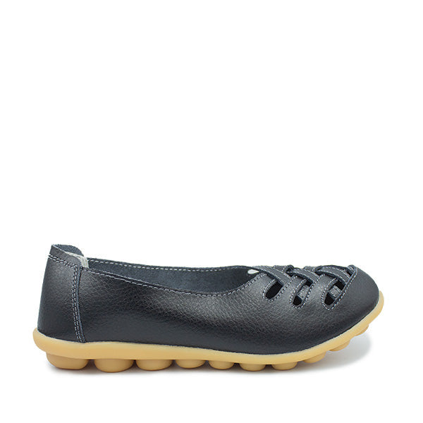 A black leather flat shoe with cut-out patterns on the upper and a lightweight sole.