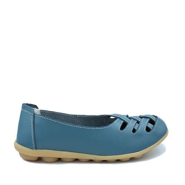 A denim blue leather shoe with cut-out patterns on the upper and a flat sole.