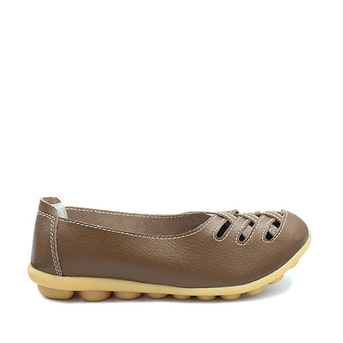 A khaki-colored, flat-heeled, genuine cow leather shoe with perforations and a round toe.