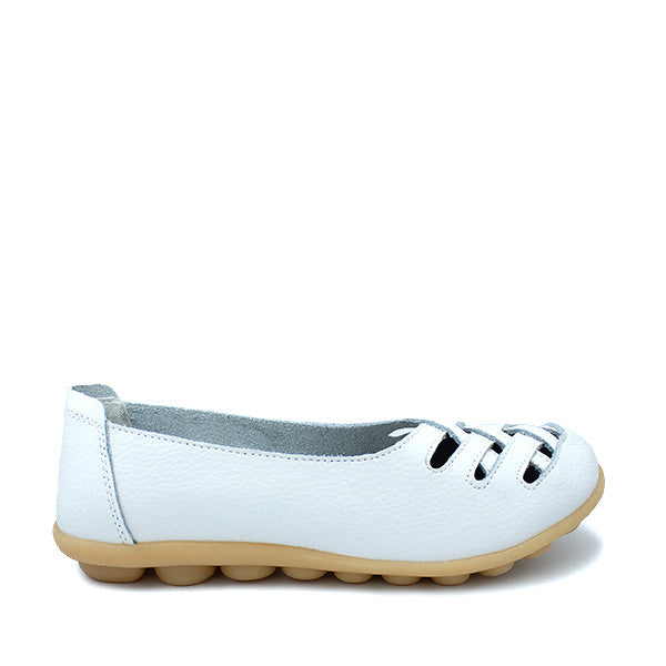 A white leather flat shoe with decorative cut-out patterns on the upper part and a light-colored sole.