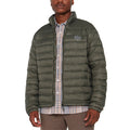 A man wearing a long sleeve murky green puffer jacket with a collar, over a striped shirt.