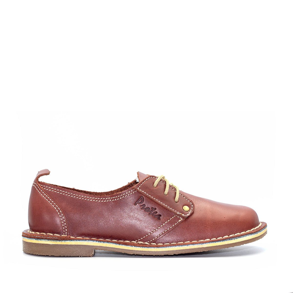 A Rust colored Protea Vellie shoe with a low heel and lace-up front, handcrafted from premium leather. Handmade in South Africa