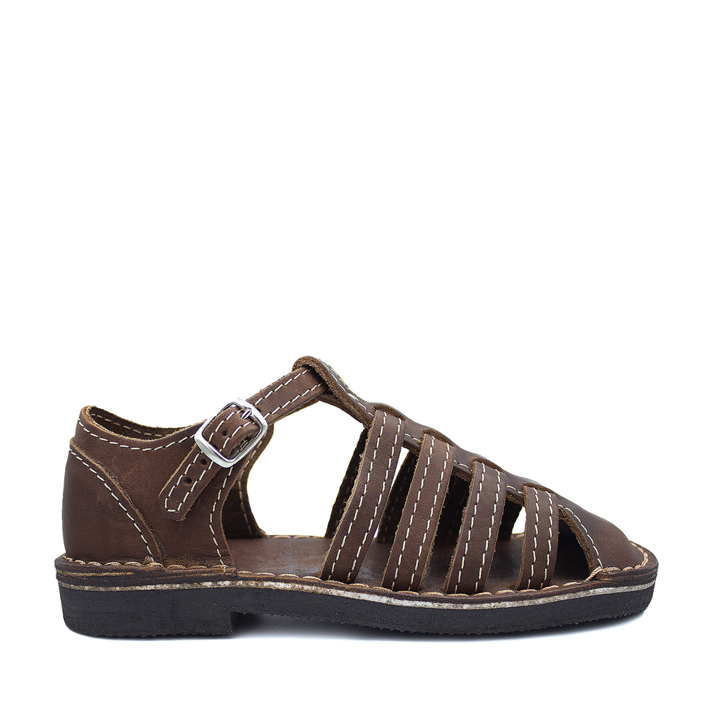 A brown strappy sandal with a buckle closure and flat sole.