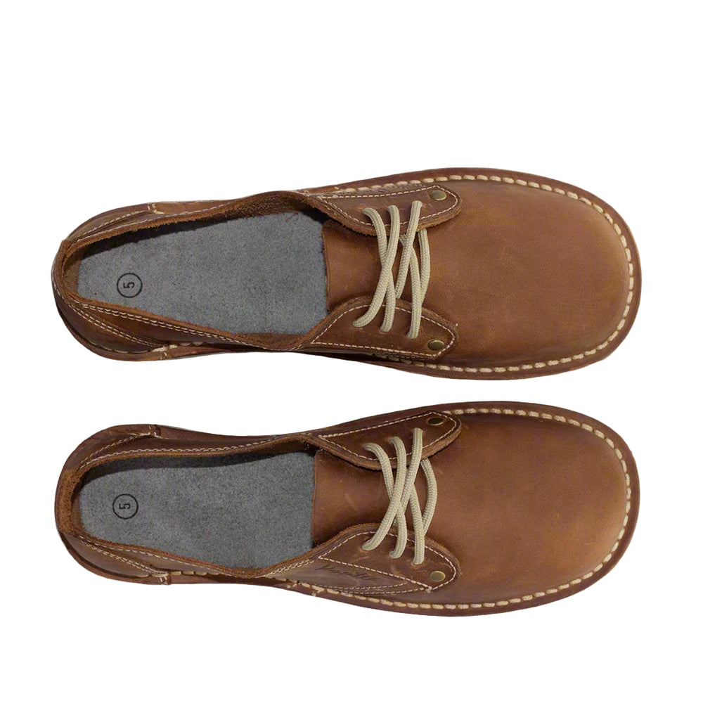 
                  
                    Brown leather shoes with white laces. Bruin leerskoene met wit veters
                  
                