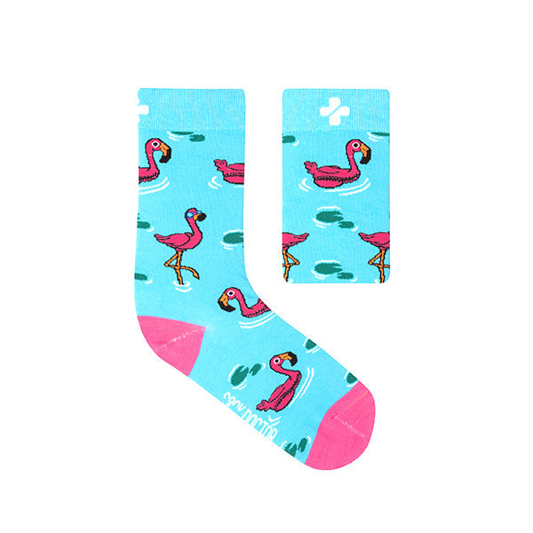 A pair of light blue socks with a pattern of pink flamingos and green accents designed by Sock Doctor.