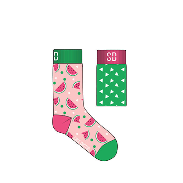 A pair of children's socks with a melon design, featuring watermelon slices on a pink background and a green geometric pattern on the cuff.