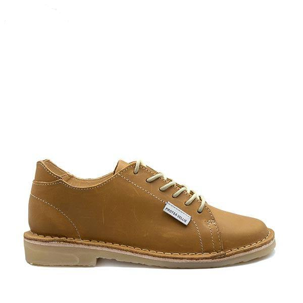 A tan-colored, full-grain leather women's vellie shoe with a smooth finish and a rubber sole, lace-up closure, and the brand label visible.