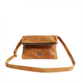 A toffee brown leather sling bag with a cross-body strap and a zippered closure.