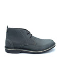 A charcoal gray Veldskoen Chukka boot with a handcrafted appearance, featuring a lace-up closure and a rubber sole.