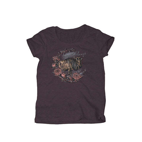A mulberry-colored ladies t-shirt with a round neckline and short sleeves. It features a central graphic print of a wildebeest with flowers around it, and the brand's logo is visible on the side.