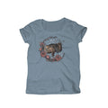 A light blue t-shirt with a round neckline and short sleeves, featuring a central illustration of a wildebeest surrounded by floral elements within a wreath, and the brand name 'Wildebees'.