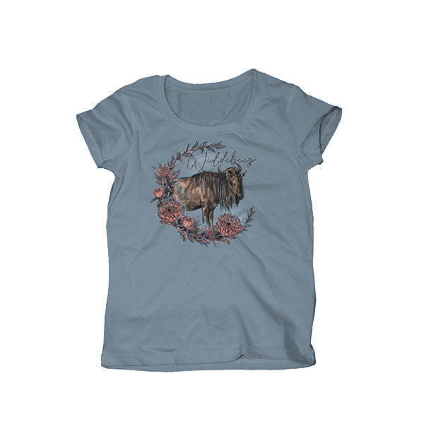 A light blue t-shirt with a round neckline and short sleeves, featuring a central illustration of a wildebeest surrounded by floral elements within a wreath, and the brand name 'Wildebees'.