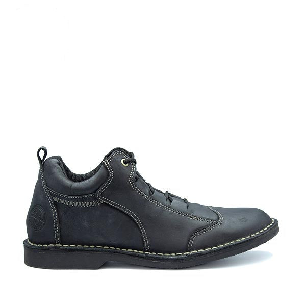A black handcrafted leather shoe with lace-up closure, featuring stitching details and a small brand logo on the heel.