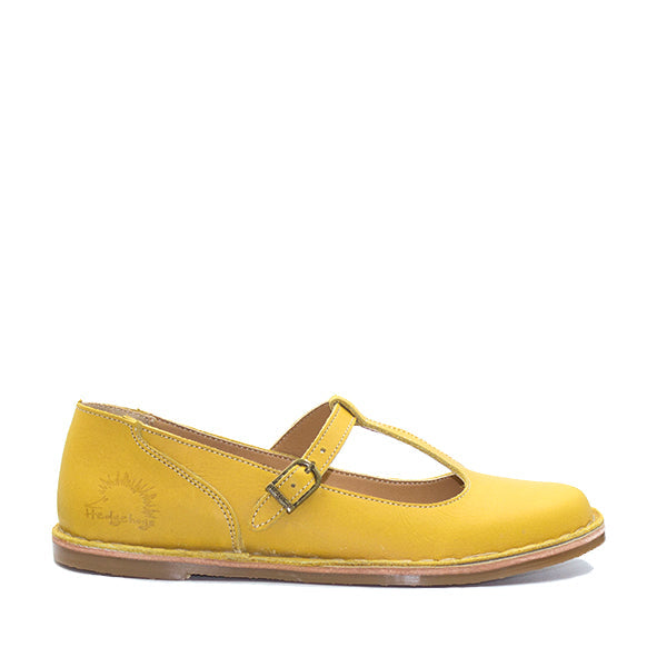 Yellow flat leather shoe with a buckle strap and the Hedgehogs brand logo on the side.