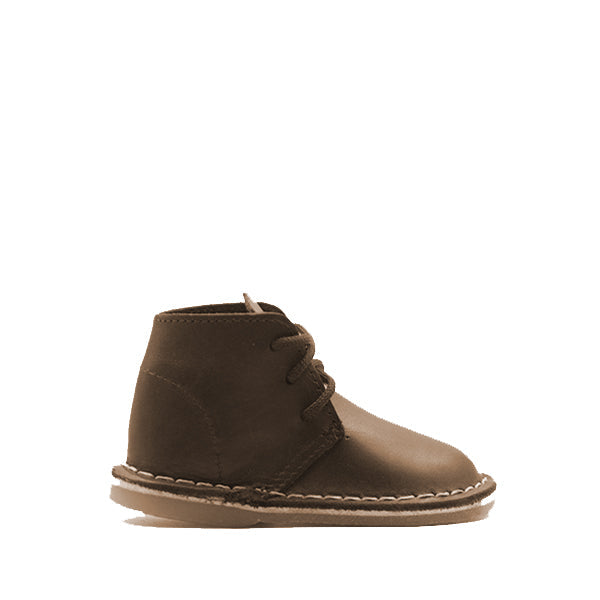 A brown leather children's shoe with a low heel and lace-up closure, made by Vellie Boutique.