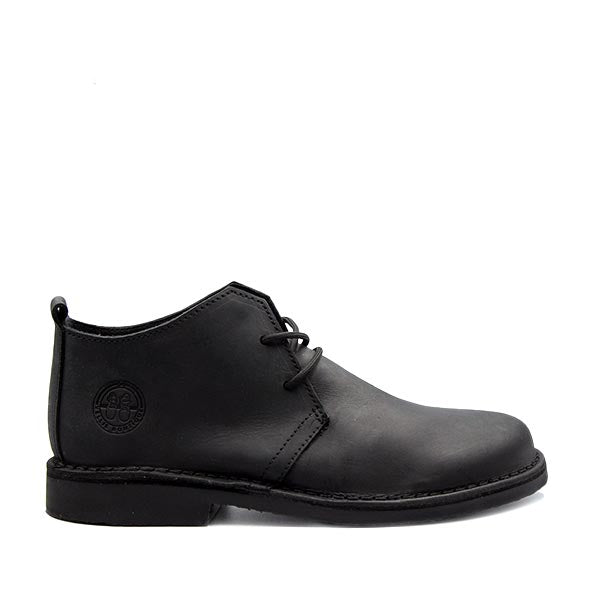 A black handcrafted leather shoe known as DKW Bosbok Vellie, featuring a lace-up closure and a low heel design.
