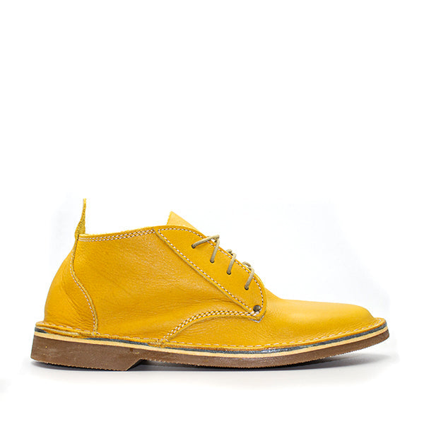 A pair of Oukraal high-cut vellies in Tobago Ochre color, featuring a lace-up closure and a slightly elevated heel.
