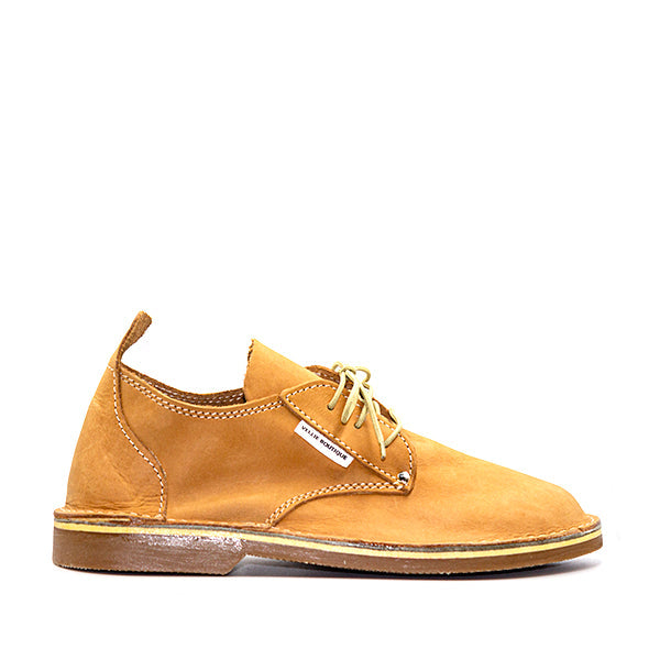 A traditional South African vellie shoe in fudge brown color with a lace-up closure and a slightly elevated heel.