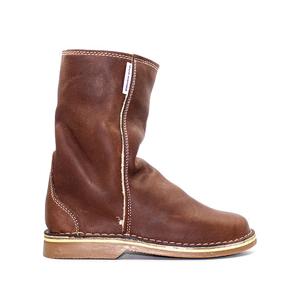 A brown leather boot with a slight heel lift and visible stitching on the shaft.