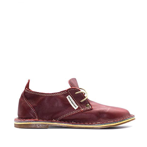 A maroon colored women's leather shoe with a low heel and lace-up closure. Handmade in South Africa